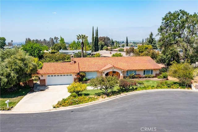 645 Alta Loma Dr, Redlands, CA 92373 - view of front facade featuring a tiled roof, stucco siding, concrete driveway, and an attached garage
