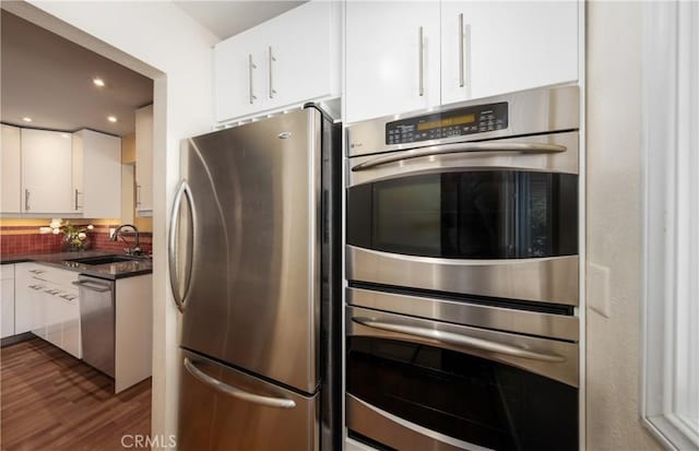 645 Alta Loma Dr, Redlands, CA 92373 - kitchen with appliances with stainless steel finishes, a sink, white cabinets, backsplash, and recessed lighting