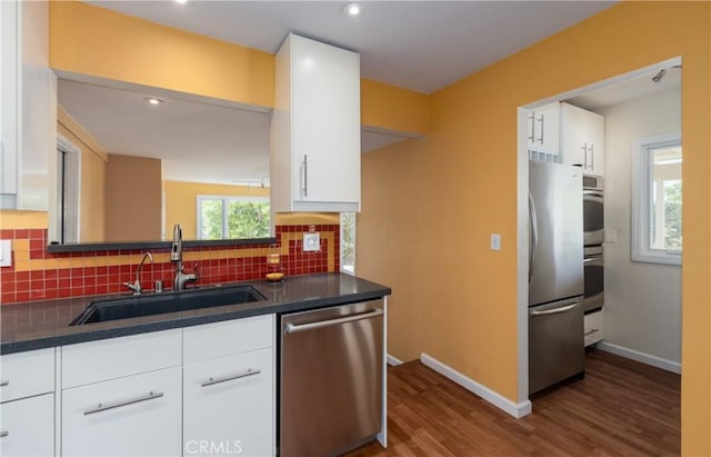 645 Alta Loma Dr, Redlands, CA 92373 - kitchen with appliances with stainless steel finishes, a sink, dark countertops, decorative backsplash, and recessed lighting