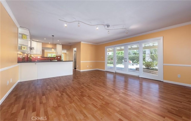 645 Alta Loma Dr, Redlands, CA 92373 - unfurnished living room with light wood-style flooring, ornamental molding, baseboards, and french doors