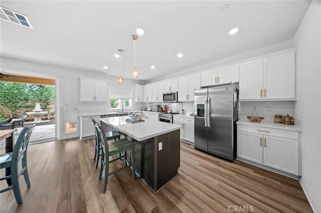 2569 Pasture Gln, Escondido, CA 92029 - kitchen with stainless steel appliances, healthy amount of natural light, a center island, white cabinets, and recessed lighting