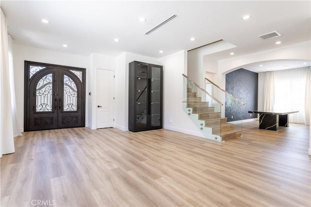 17195 Summit Hills Dr, Canyon Country, CA 91387 - foyer with arched walkways, light wood finished floors, stairway, french doors, and healthy amount of natural light