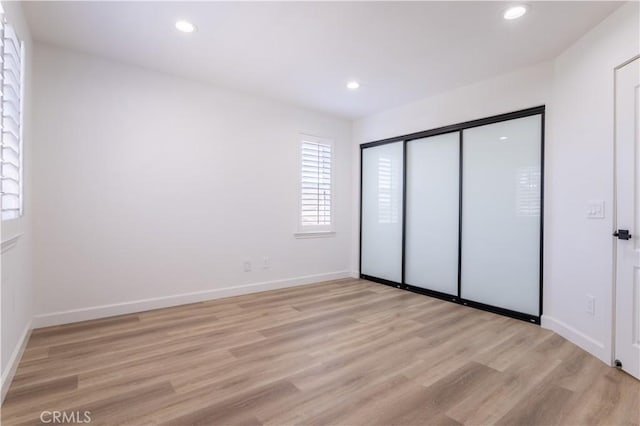 17195 Summit Hills Dr, Canyon Country, CA 91387 - unfurnished bedroom featuring light wood-style floors, recessed lighting, baseboards, and a closet