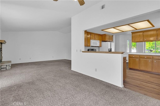 904 Torrey Pines Dr, Paso Robles, CA 93446 - kitchen featuring white appliances, light colored carpet, ceiling fan, lofted ceiling, and light countertops