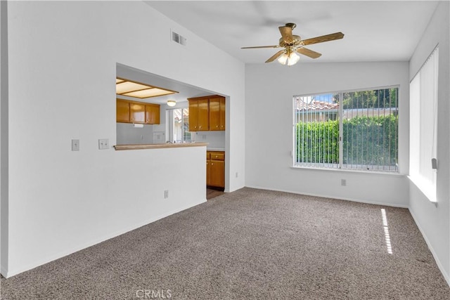904 Torrey Pines Dr, Paso Robles, CA 93446 - unfurnished living room with dark colored carpet, a ceiling fan, and healthy amount of natural light