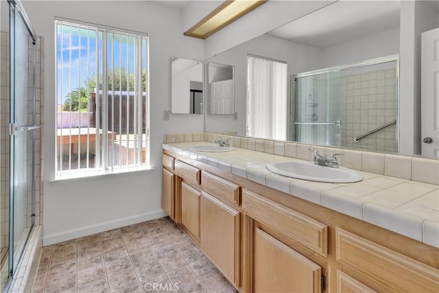 904 Torrey Pines Dr, Paso Robles, CA 93446 - bathroom featuring baseboards, a tile shower, and double vanity
