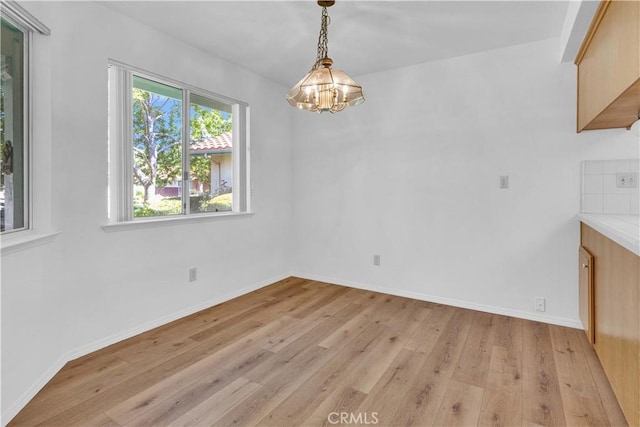 904 Torrey Pines Dr, Paso Robles, CA 93446 - unfurnished dining area featuring a chandelier, light wood-style floors, and baseboards