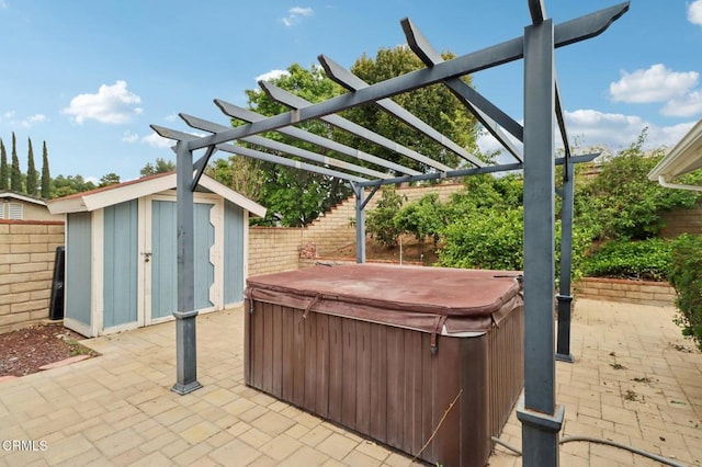 22573 Honnold Dr, Santa Clarita, CA 91350 - view of patio / terrace with a hot tub, a shed, a fenced backyard, and an outbuilding