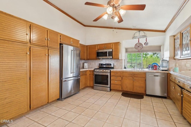 22573 Honnold Dr, Santa Clarita, CA 91350 - kitchen featuring appliances with stainless steel finishes, tasteful backsplash, light tile patterned floors, ornamental molding, and tile counters