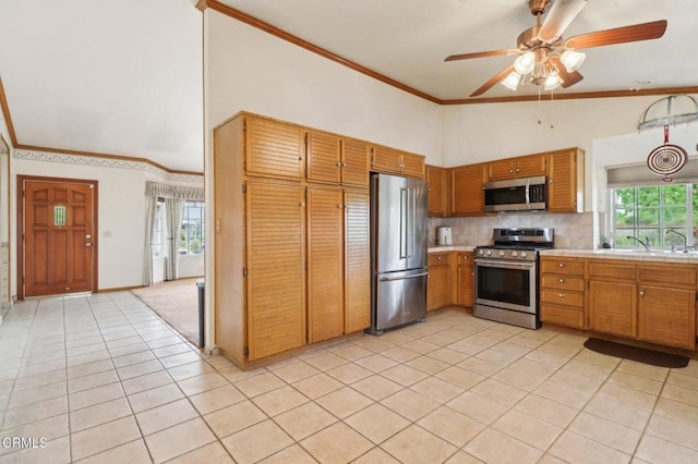 22573 Honnold Dr, Santa Clarita, CA 91350 - kitchen with stainless steel appliances, light tile patterned floors, crown molding, a ceiling fan, and decorative backsplash
