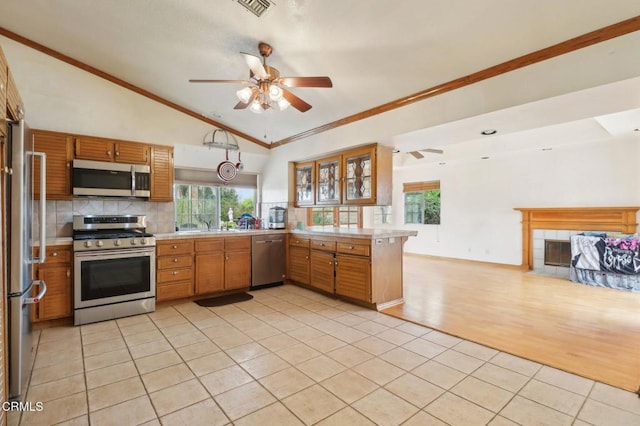 22573 Honnold Dr, Santa Clarita, CA 91350 - kitchen with appliances with stainless steel finishes, a ceiling fan, light tile patterned flooring, light countertops, and lofted ceiling