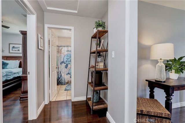 hall with wood finished floors and baseboards