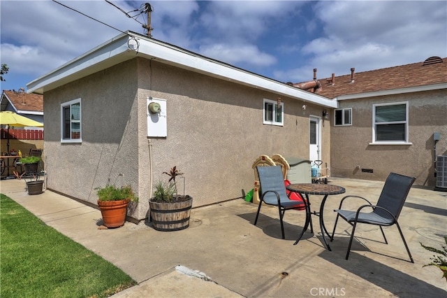 rear view of property featuring a patio area and stucco siding
