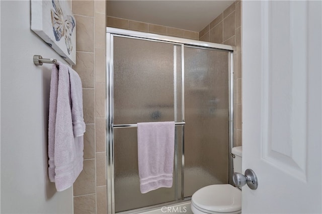 full bath with a shower stall and toilet