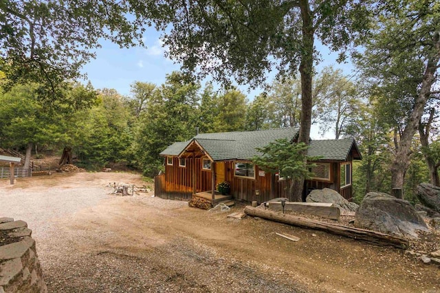 21932 Crestline Rd, Palomar Mountain, CA 92060 - rear view of property with dirt driveway, board and batten siding, and a shingled roof