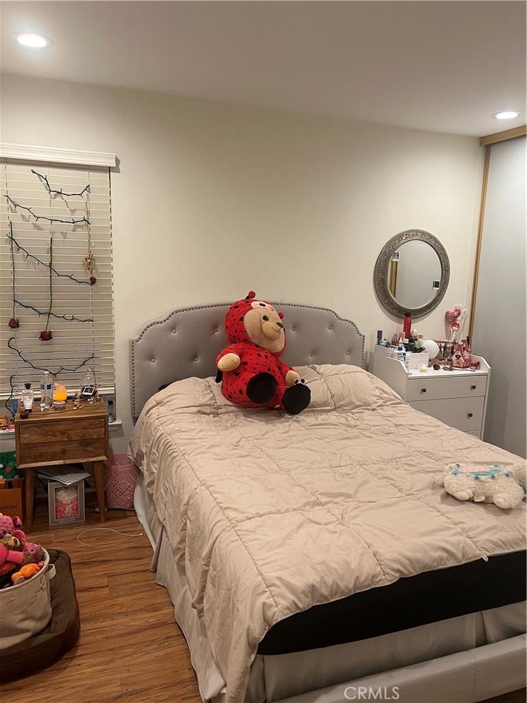 bedroom with wood finished floors and recessed lighting