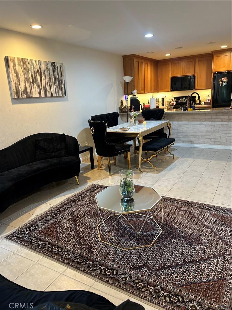 living area featuring light tile patterned flooring and recessed lighting