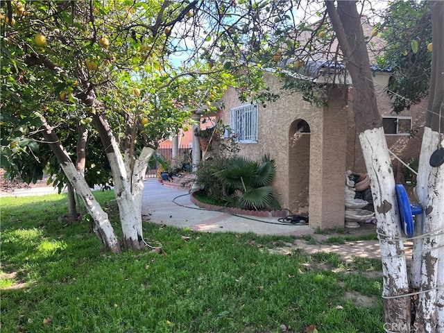 702 N Burris Ave, Compton, CA 90221 - view of property exterior featuring stucco siding and a lawn