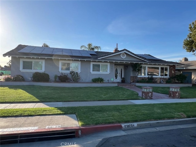 13631 Utt Dr, Tustin, CA 92780 - ranch-style home with a front lawn, solar panels, and stucco siding