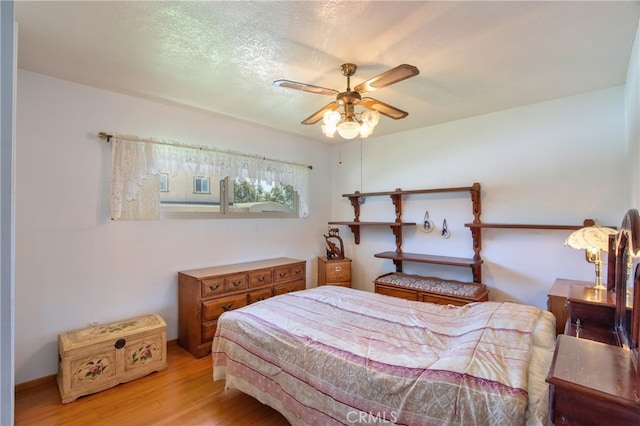 bedroom with light wood-type flooring and ceiling fan