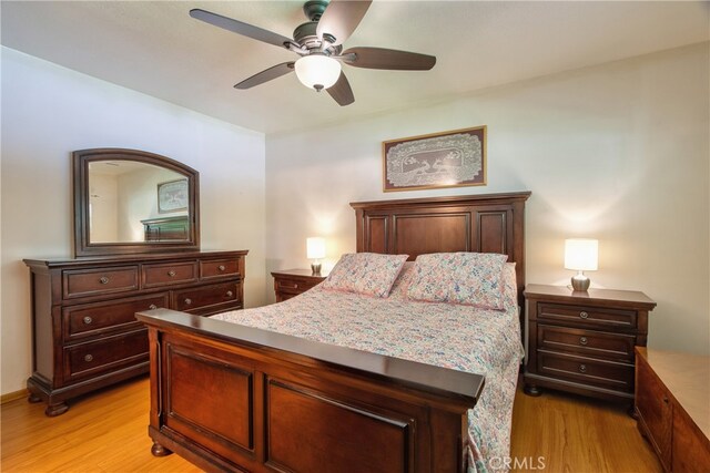 bedroom with light wood-type flooring and ceiling fan