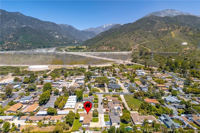 aerial overview of property's location featuring a mountainous background and nearby suburban area