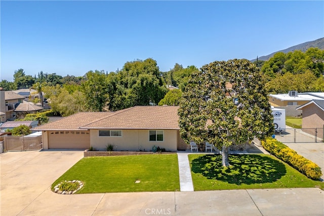 view of front of home featuring concrete driveway, stucco siding, a garage, and a gate