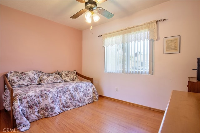 bedroom with wood finished floors, baseboards, and a ceiling fan