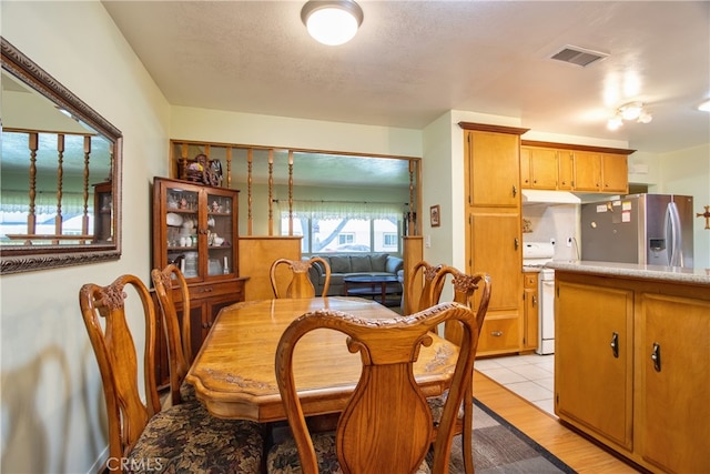 dining area with light wood finished floors