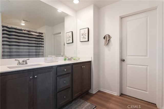 959 Rockcress Ln, Banning, CA 92220 - bathroom with wood finished floors, baseboards, and double vanity