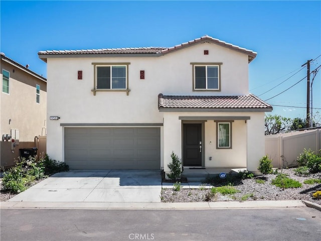 959 Rockcress Ln, Banning, CA 92220 - mediterranean / spanish home featuring a tile roof, fence, an attached garage, stucco siding, and driveway