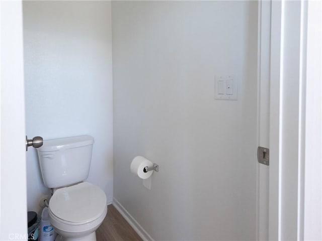 959 Rockcress Ln, Banning, CA 92220 - bathroom with toilet, wood finished floors, and baseboards