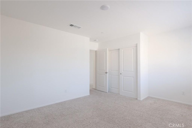 959 Rockcress Ln, Banning, CA 92220 - unfurnished bedroom featuring light carpet, a closet, and baseboards