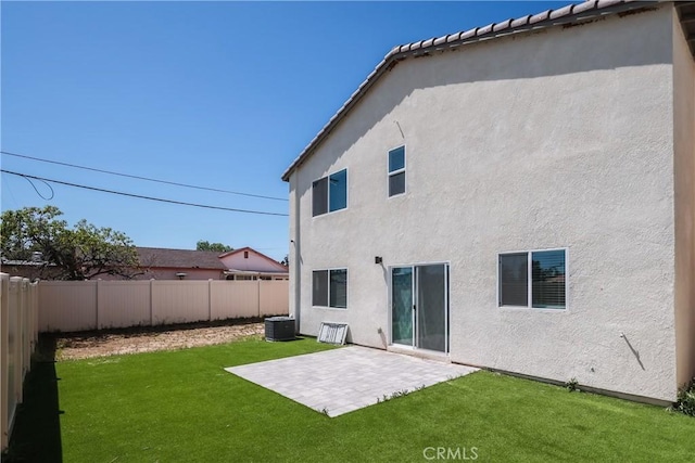 959 Rockcress Ln, Banning, CA 92220 - rear view of house with stucco siding, central AC, and a patio