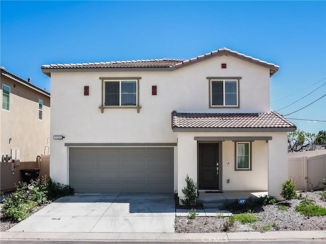 959 Rockcress Ln, Banning, CA 92220 - mediterranean / spanish home with a tiled roof, stucco siding, fence, an attached garage, and concrete driveway