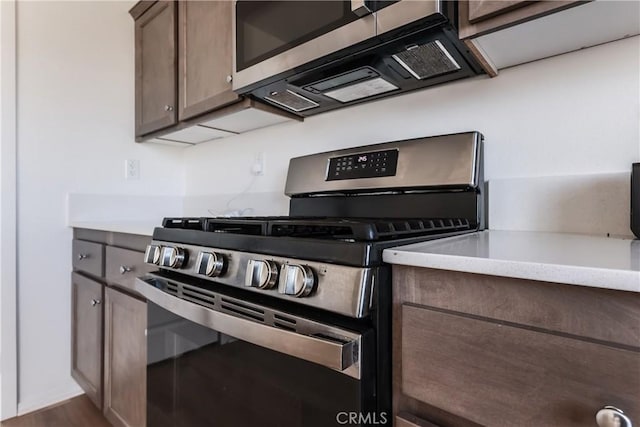 959 Rockcress Ln, Banning, CA 92220 - kitchen featuring stainless steel appliances, light countertops, dark brown cabinetry, and dark wood-style flooring