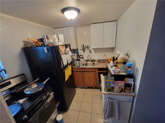 2112 E Lucien St, Compton, CA 90222 - kitchen with gas range, a sink, a textured ceiling, white cabinetry, and light countertops