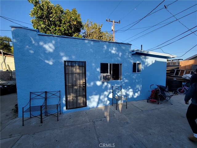 2112 E Lucien St, Compton, CA 90222 - rear view of house with stucco siding, a patio area, and cooling unit