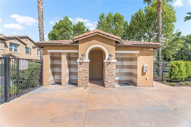 28116 Calle Lumina, Temecula, CA 92592 - view of front facade with stucco siding, fence, a tile roof, stone siding, and concrete driveway