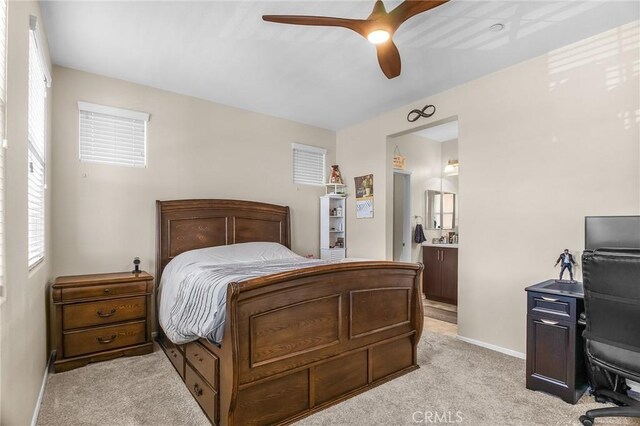 28116 Calle Lumina, Temecula, CA 92592 - bedroom with light colored carpet, baseboards, a desk, connected bathroom, and ceiling fan
