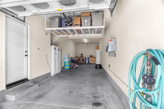 28116 Calle Lumina, Temecula, CA 92592 - garage featuring white refrigerator with ice dispenser and baseboards
