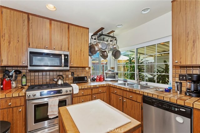 7030 Idyllwild Ln, Riverside, CA 92503 - kitchen featuring appliances with stainless steel finishes, a sink, tile counters, backsplash, and recessed lighting