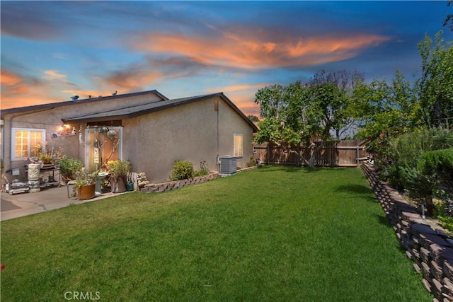 7030 Idyllwild Ln, Riverside, CA 92503 - yard at dusk with central air condition unit and a patio area