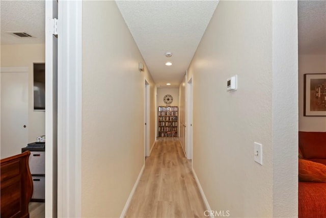 7030 Idyllwild Ln, Riverside, CA 92503 - hall with a textured ceiling, light wood-style floors, recessed lighting, and baseboards