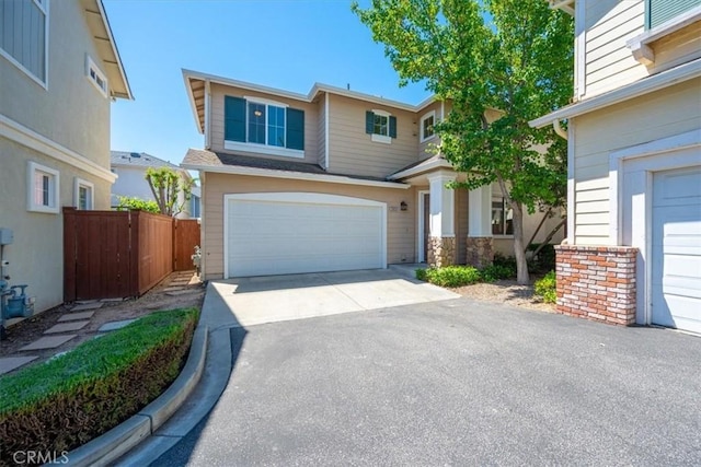 2923 Cottage Ln, Paso Robles, CA 93446 - view of front of property with asphalt driveway, fence, an attached garage, and stone siding