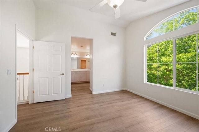 2923 Cottage Ln, Paso Robles, CA 93446 - unfurnished bedroom with light wood-type flooring, baseboards, and connected bathroom
