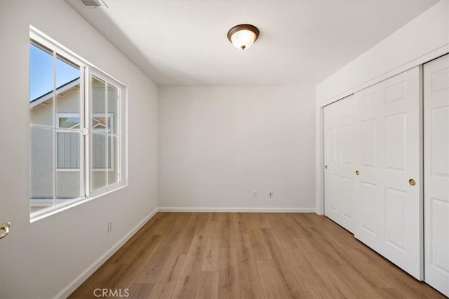 2923 Cottage Ln, Paso Robles, CA 93446 - unfurnished bedroom with light wood-style floors, a closet, and baseboards