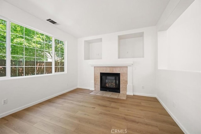 2923 Cottage Ln, Paso Robles, CA 93446 - unfurnished living room featuring wood finished floors, a fireplace, and baseboards