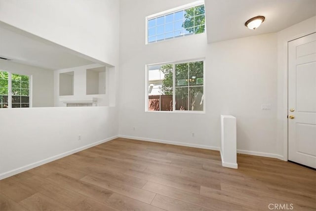 2923 Cottage Ln, Paso Robles, CA 93446 - spare room with wood finished floors, baseboards, and a towering ceiling