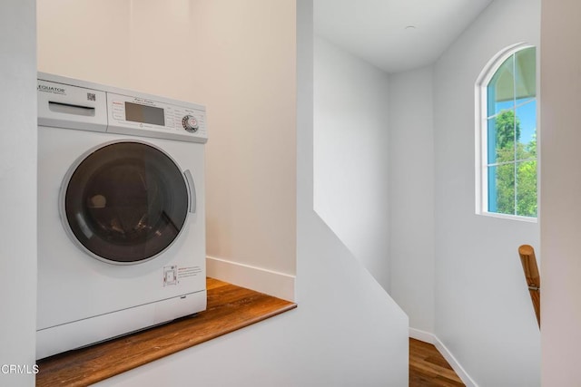 laundry room with washer / clothes dryer, baseboards, and wood finished floors